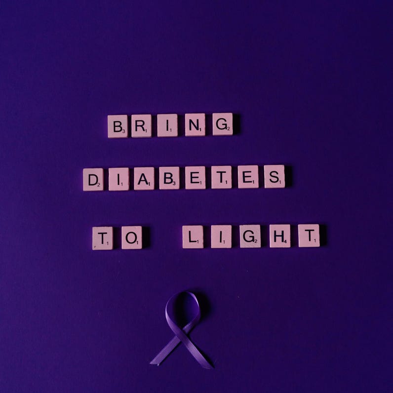 Scrabble tiles arranged to raise diabetes awareness on a purple background.